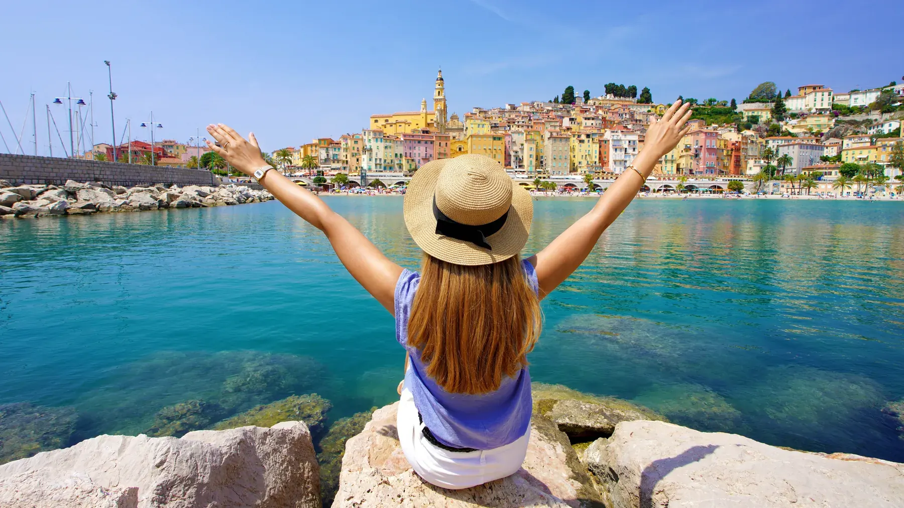 A woman travelling alone facing Menton old town